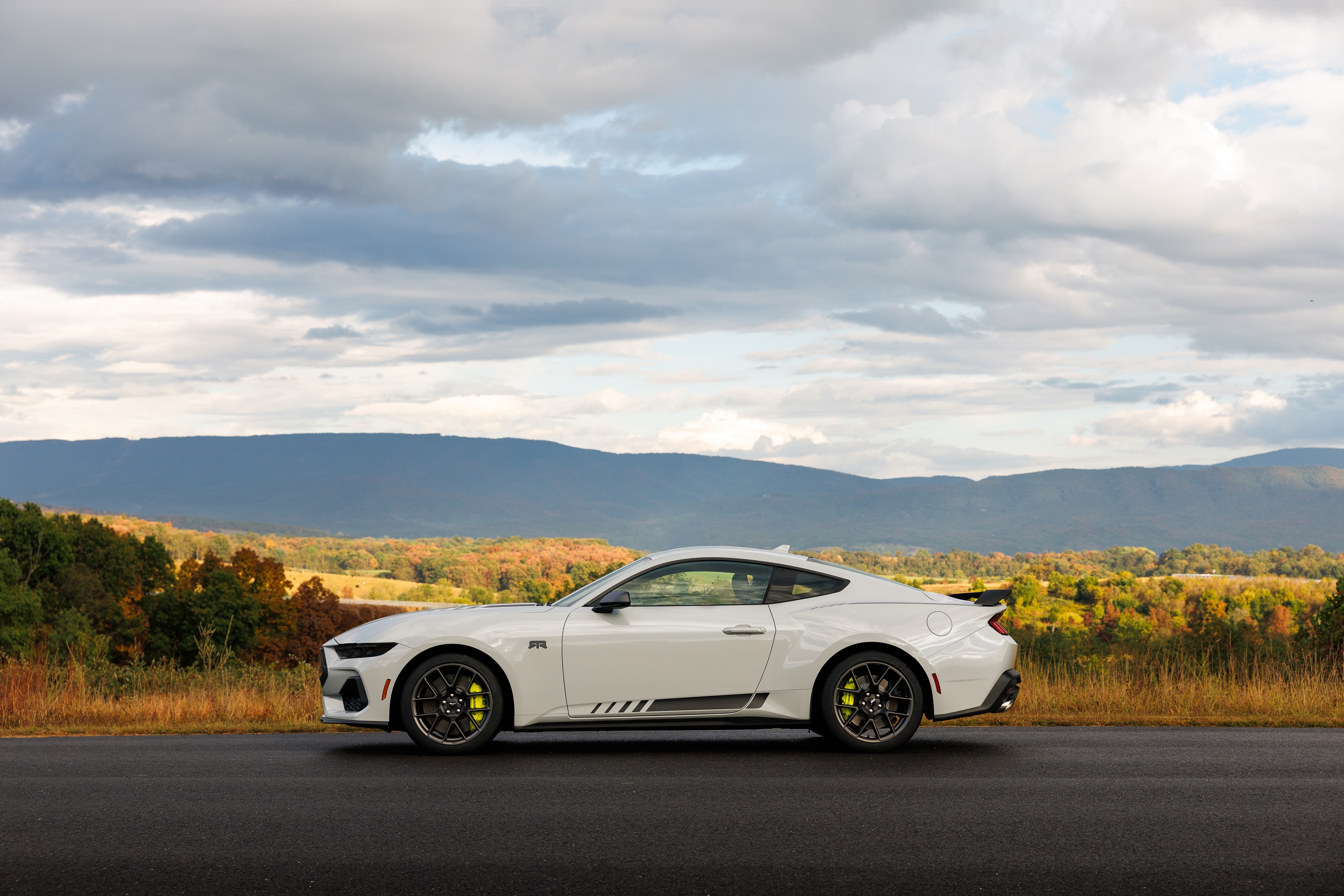 Optional RTR package available on 2026 Ford Mustang EcoBoost fastback. Preproduction model shown with optional Hyper Lime brake caliper shown. Available late spring 2026.